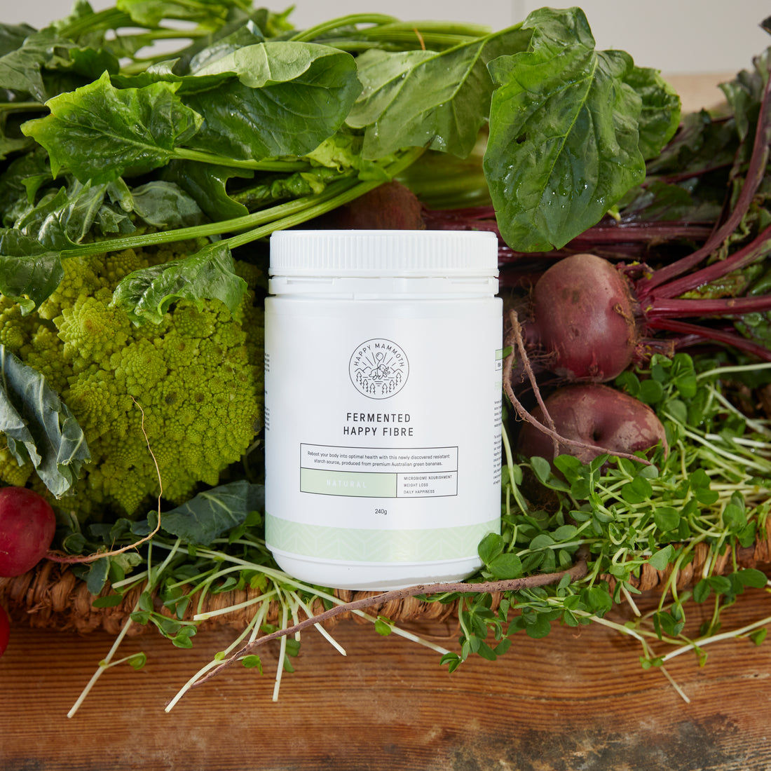 supplement bottle surrounded by root vegetables