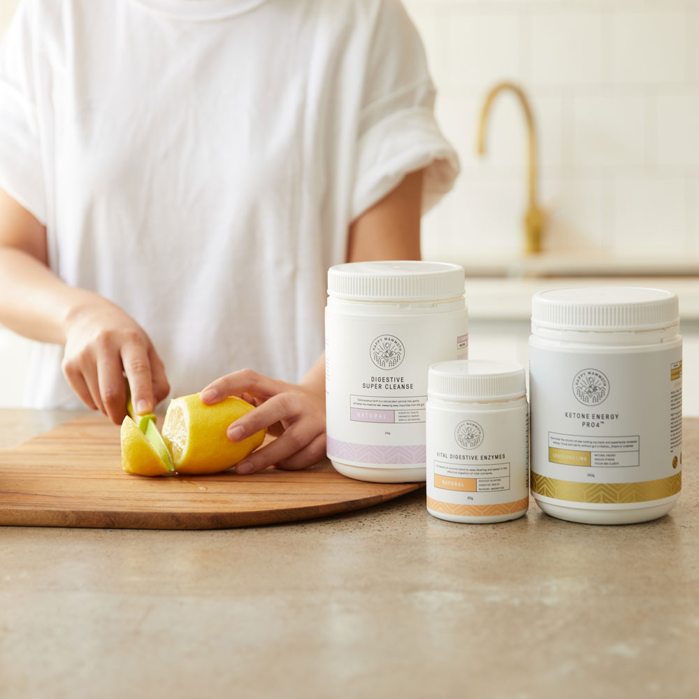 woman cutting lemons next to supplements