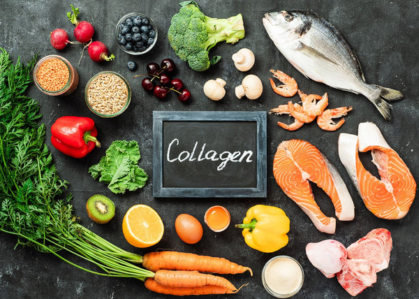 The word collagen on a chalk board surrounded by healthy food