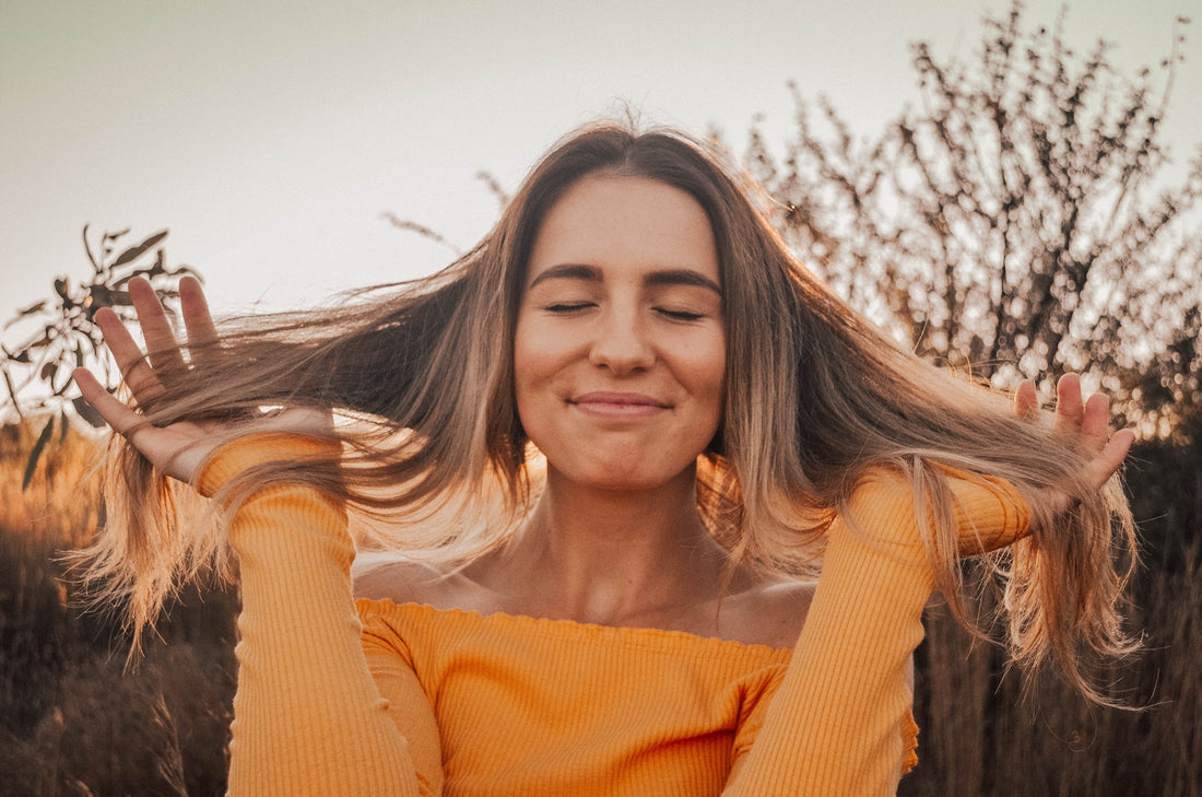 A happy woman plays with her hair