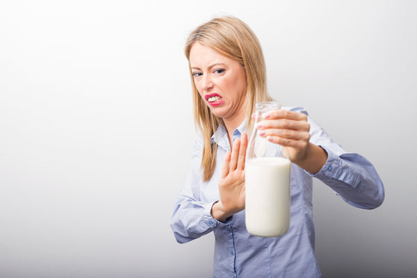 Woman suffering from a food sensitivity, intolerance or allergy to milk