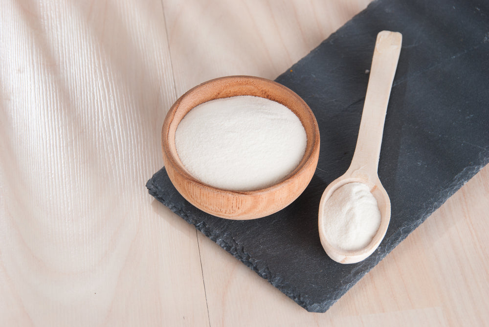 white powder in a bowl with a spoon next to it