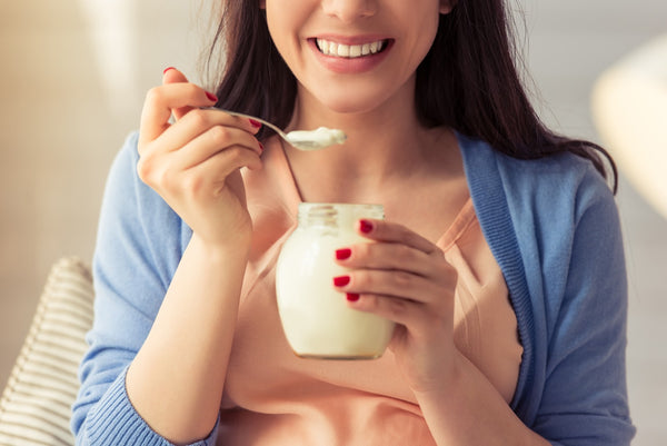 A woman eating yogurt