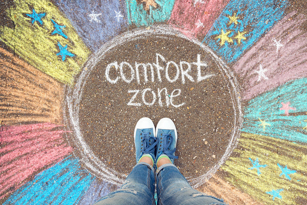 "comfort zone" in chalk with feet in the middle 