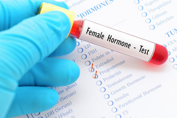 doctor holding a tube labeled female hormone