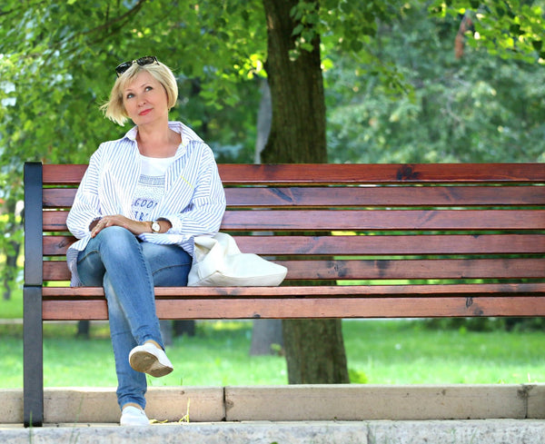 A woman sitting on a park bench